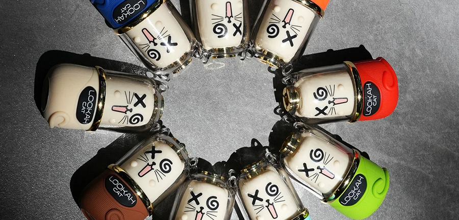 Circular arrangement of small containers with labels on a gray background